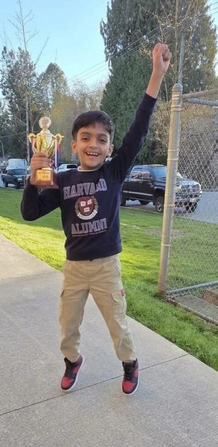 Student Amruth celebrating tournament win with trophy
